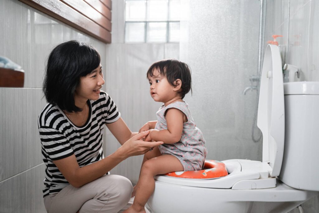 Mother toilet training her child